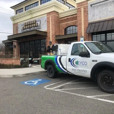Reyco truck parked outside of a commercial building